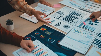 Poster - Professional setting showing hands collaborating over various analytics charts and reports, emphasizing teamwork and strategic planning in a business environment. SACTR