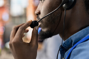 Poster - Call center agent wearing headset at office desk resolving customers concerns, talking into microphone. Close up of customer service staff member using headphones mic processing clients orders