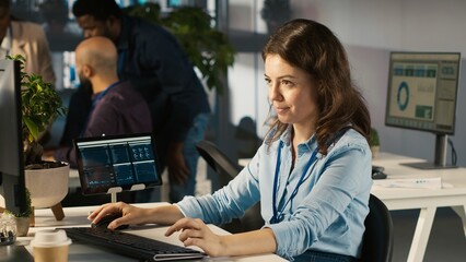 Poster - Employee at office desk typing on keyboard, editing documents on computer. Worker inputting data on spreadsheets in workplace at PC, working on statistical information, camera A