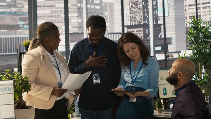 Poster - Employees and coworker with disability looking over revenue figures in inclusive office. Man in wheelchair working together with colleagues, comparing company statistical numbers, camera A
