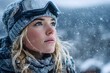 © Oleh - Young woman skier wearing ski goggles and winter clothes looking up at the falling snow during a snowstorm in the mountains, enjoying the beauty of nature