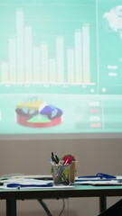 Poster - Vertical Video Empty office of corporation reveals a boardroom with forecast reports and digital graphs running on a huge projection board late at night. Aligning management goals and targets.