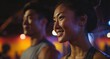 © Surachetsh - A confident woman leads her treadmill routine with a joyful expression, while a diverse group in the gym exercises together, showcasing teamwork and mutual support.