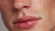 © JoeyMarut - Close up of male lips with subtle freckles and natural skin texture, showing soft balm on lower lip for gentle and hydrated appearance