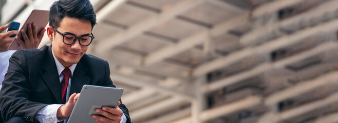 Banner Man hands typing laptop notebook holding coffee cup outside office. Panorama man hands using computer laptop sit on green park. Freelance Men use laptop home office technology with copy space