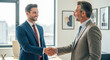 © SOEM - Two men shaking hands in an office setting.