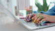 © CL STOCK - Hands typing on laptop with floating digital profile cards. Concept of online collaboration platform, remote team management, user data, virtual workspace, and professional networking tools.