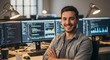 © graphicview35 - Photo of a smiling programmer poses confidently in front of multiple monitors