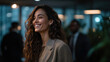 © Nattapol - Smiling woman with curly hair wearing blazer in office environment