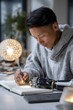© ЮРИЙ ПОЗДНИКОВ - Young designer drawing with prosthetic arm in modern office