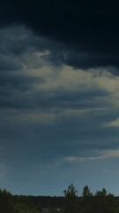 Wall Mural - Time Lapse Dramatic Sky With Heavy Rain Clouds Above Forest. Time-lapse Colorful Cloudy Dark Blue Sky Fluffy Clouds. Rain Above Forest Landscape. Rain Cloud Formation Timelapse. Dark Sky. Bad Weather