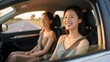 © Peter - Two women enjoying a car ride, smiling and looking out the window on a sunny day