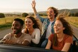 © woters - Friends enjoying a summer road trip in a convertible along a scenic rural road during sunset