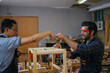 © Suney - Carpenters are working together at workshop.