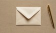 © Valfiyy - Elegant stationery composition featuring a cream envelope and gold pen