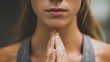 © Oksana_Tukane - Close-up of a young woman meditating or praying with hands clasped together. faceless, lips close up. selective focus.