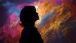 © Elegant Collections - Silhouette of a person wearing VR headset against a vibrant abstract colorful background virtual reality