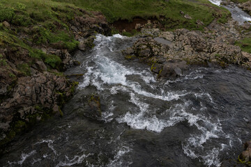 Canvas Print - creek water flowing between rocks.