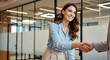 © Passionwith - Confident Businesswoman Shaking Hands in Modern Office