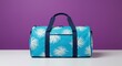 © si9nzation - Stylish blue travel duffel bag with palm leaves print for vacation or weekend getaway on purple background