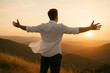 © Olinka N - Man enjoying sunset view in mountains with arms wide open