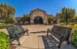 © thodonal - Town hall building with benches under clear blue sky