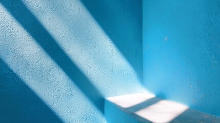 Poster - Blue wall with sunlight casting shadows in a calm and serene interior space