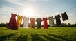© Helon'artStockStudio - Colorful dresses drying on a clothesline in a sunny field