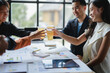 © PaeGAG - Business team celebrating good results toasting with beer in the office