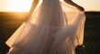© Mairon - Close-up of flowing tulle dress in golden sunlight, evoking elegance and romance.