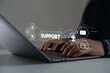 © MUNTHITA - Technician typing on laptop keyboard with virtual digital interface icons, chat, email, AI, service tools. online customer service, technical assistance, IT support, remote troubleshooting, help desk.