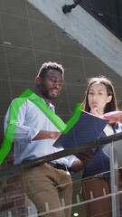 Poster - Animation of graph with changing numbers over diverse coworkers discussing in balcony of office