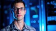 © Alger - A technical specialist in glasses stands confidently before a server rack, representing expertise in technology.