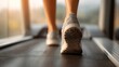 © WS Studio 1985 - Treadmill stride: An invigorating shot capturing the rhythmic motion of running feet on a treadmill, set against a soft, natural backdrop, perfect for promoting health and wellness.