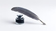 © Debi Kurnia Putra - Vintage grey feather quill pen with a glass inkwell for classic calligraphy and writing