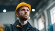 © YU - An industrial engineer in a safety helmet, portrayed in a factory setting with a soft background.