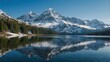 © Abu Bakar - A scenic view of a lake reflecting snow capped mountains and evergreen trees on a clear day