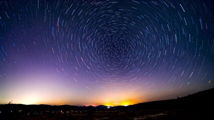 Wall Mural - arafed image of a star trail in the sky with a mountain in the background