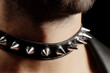 © alexkoral - man's neck in a stylish fashion leather choker with metal spikes. A BDSM accessory for sex games with submission and domination for a submissive male slave