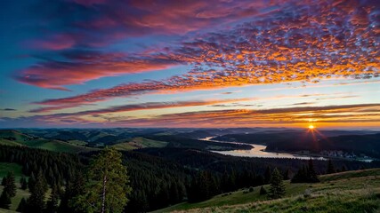 Wall Mural - arafed view of a beautiful sunset over a lake and mountains
