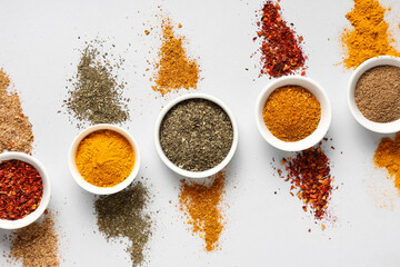 Wall Mural - Composition with bowls of different spices on grey background
