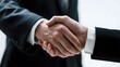 © Bob - Two individuals in formal attire engaging in a handshake.