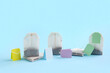 © Pixel-Shot - Different tea bags on blue background, closeup