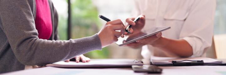 Asian adult hands business professionals collaborating digital documents tablet signing agreement office meeting modern technology