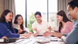 © Pichsakul - Asian young adult professionals collaborate brainstorm ideas meeting discussion new business project modern office teamwork happy colleagues productive work environment bright space
