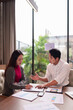 © Pichsakul - Asian business professionals discussing marketing data signing documents collaborating in modern office meeting room for project success