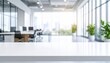 © Dzunstock - A bright, modern office space featuring a sleek white countertop, large windows, and greenery, creating a productive and inviting atmosphere.