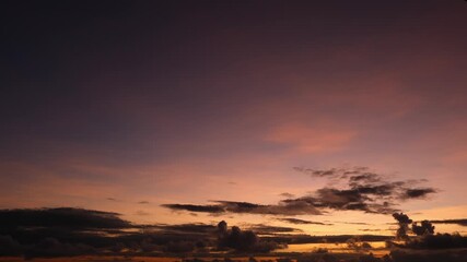 Wall Mural - a timelapse video captures a stunning sunrise sky with the sun rising near the horizon, casting warm