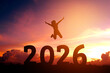 © joyfotoliakid - 2026 Newyear Silhouette young woman jumping to Happy new year concept.