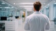 © Ammad - A determined doctor strides through the modern hospital towards urgent care showcasing dedication and healthcare in a